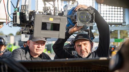 Behind the scenes of “Furiosa: A Mad Max Saga”: Cinematographer Simon Duggan ASC, ACS (left) with Gaffer Shaun Conway, who adjusts an ARRI Orbiter.